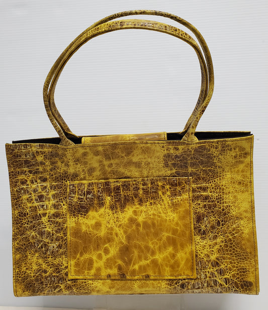 every day or carry on size distressed yellow and brown sturdy leather tote with inside pockets, colorful lining and large front outside pocket
