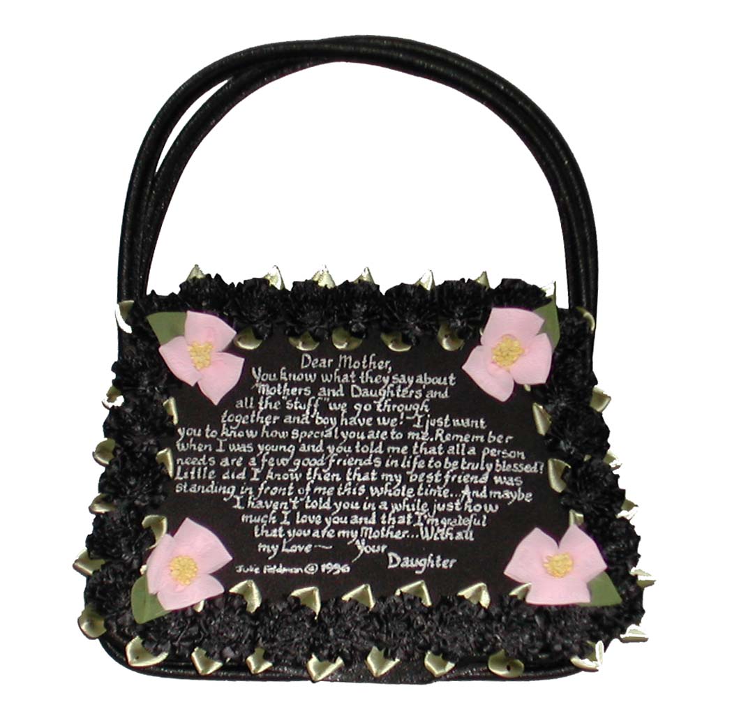 black satin evening purse bordered in black ribbon carnation and a pink chiffon flower in each corner that surrounds a handwriiten message that starts with Dear Mother