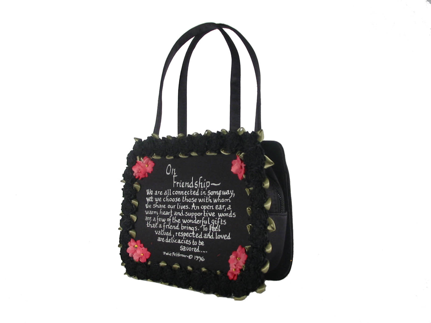 black satin evening bag with On Friendship written message with black silk carnation around the border and delicate corner flower accents