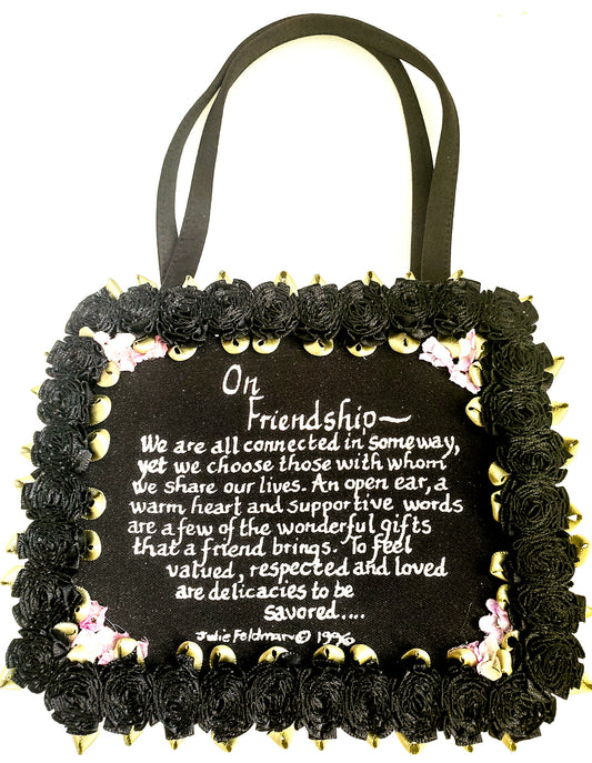 black satin evening bag with On Friendship written message with black silk carnation around the border and delicate corner flower accents